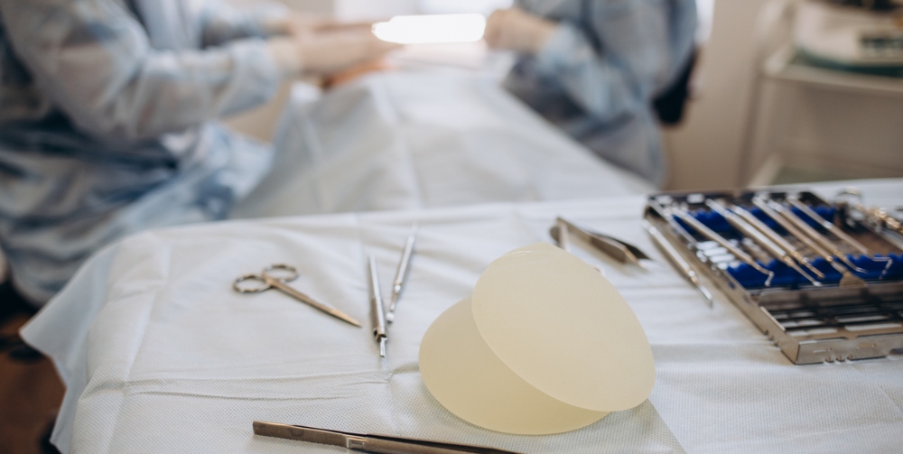 surgeon working on a patients breasts