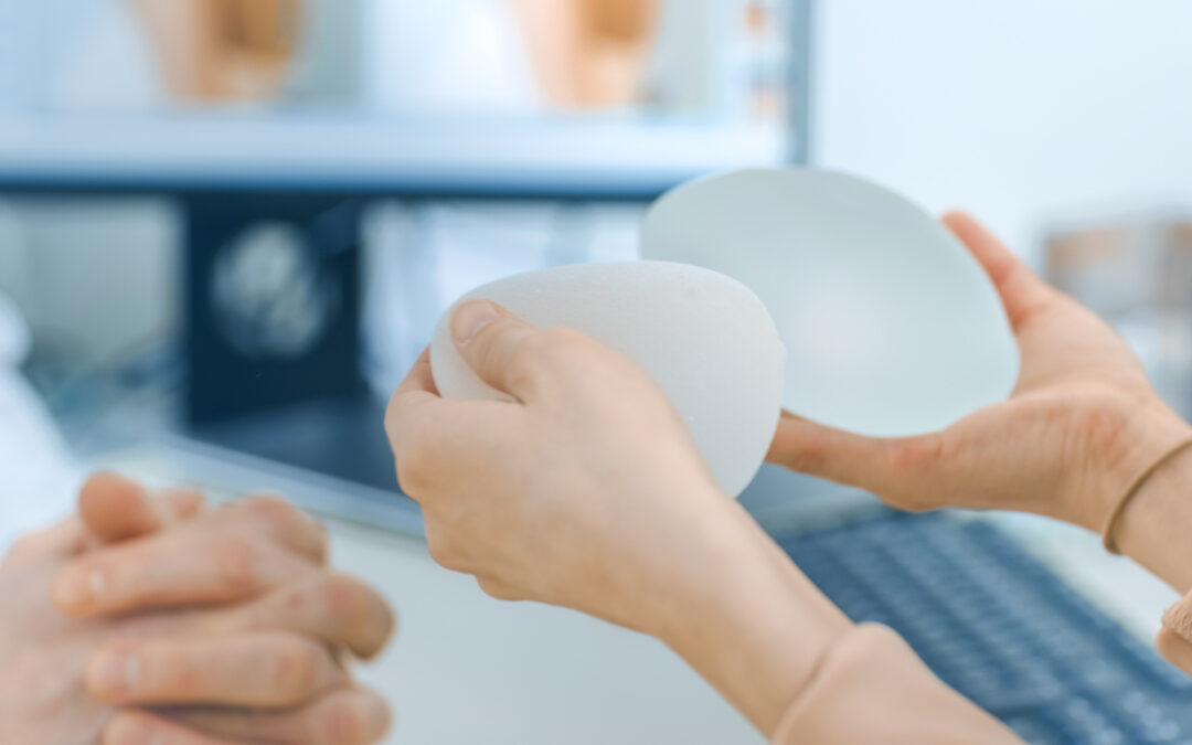 Cosmetic Surgeon Shows Female Patient Breast Implant Samples