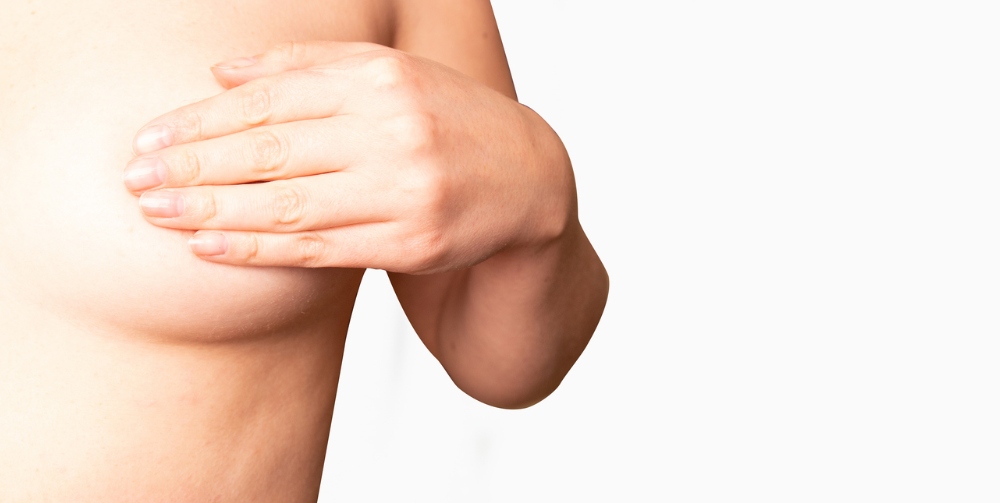 Close Up cropped portrait young woman with breast pain touching chest