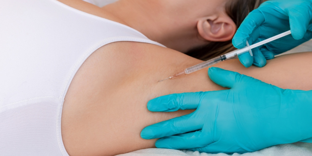 clinician injecting botox in the underarm